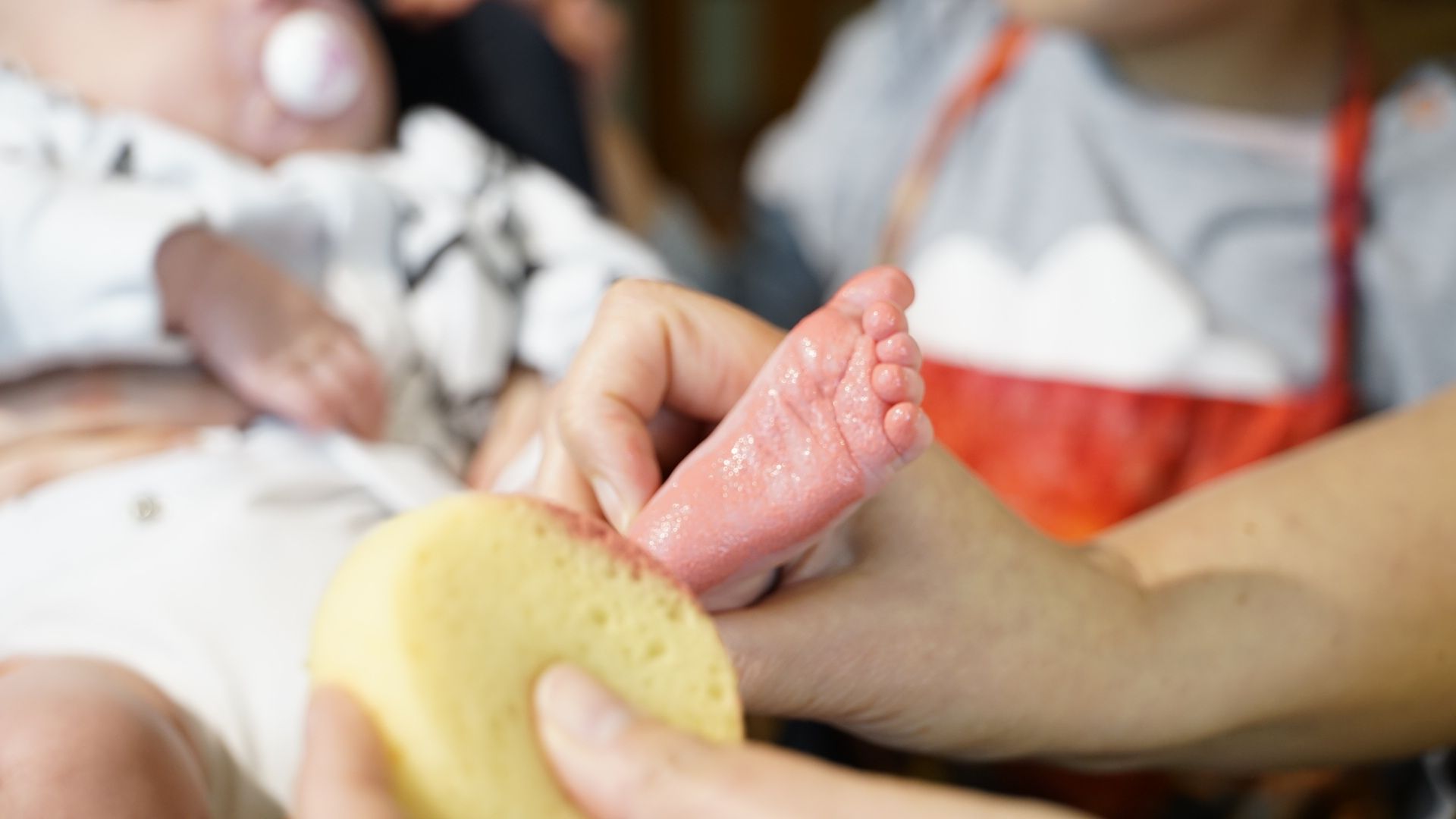 red-paint-on-newborn-baby-feet-for-prints